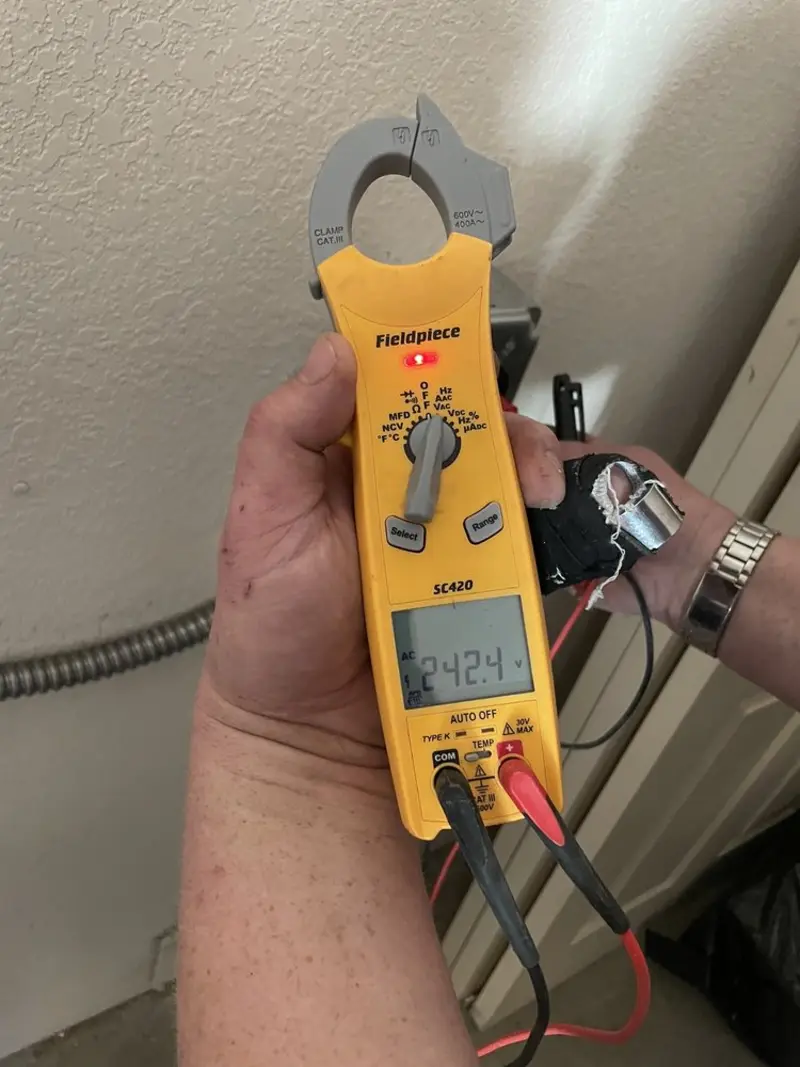 Voltage testing with clamp meter during Recessed Lighting Installation in Briarcliff Manor